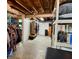 Spacious basement area with exposed wood ceiling and ample storage, perfect for organization at 2143 N Graham Ave, Indianapolis, IN 46218