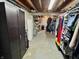 Basement storage area featuring open ceilings, concrete floors, and storage shelves at 2143 N Graham Ave, Indianapolis, IN 46218