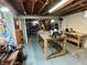 Basement workshop with a workbench, various tools, and ample lighting for projects at 2143 N Graham Ave, Indianapolis, IN 46218