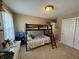A well-lit bedroom with a bunk bed, desk, and light walls makes for a cozy yet versatile area at 2143 N Graham Ave, Indianapolis, IN 46218
