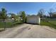 Detached one car garage with long driveway and a chain link fence for added security at 2143 N Graham Ave, Indianapolis, IN 46218