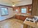 Traditional kitchen featuring wooden cabinetry, vintage appliances, and a window at 2309 Pennsylvania St, Columbus, IN 47201
