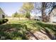 The green backyard features landscaping and a shed at the back of the property at 233 N Fenton Ave, Indianapolis, IN 46219