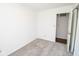 Clean bedroom with a closet and neutral carpet with freshly painted white walls at 233 N Fenton Ave, Indianapolis, IN 46219