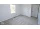 Bedroom with window, light gray carpet, and closet creates a calming and inviting atmosphere at 233 N Fenton Ave, Indianapolis, IN 46219