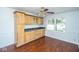Dining room featuring hardwood floors, custom cabinetry, and a ceiling fan at 233 N Fenton Ave, Indianapolis, IN 46219