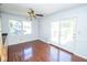 Bright dining room featuring hardwood floors, a ceiling fan, and sliding glass doors to the back patio at 233 N Fenton Ave, Indianapolis, IN 46219