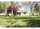 Lovely single-Gathering home with a green lawn and mature trees showcasing classic suburban living at 233 N Fenton Ave, Indianapolis, IN 46219