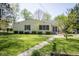 Inviting view of house with manicured lawn and landscaping in the front yard at 233 N Fenton Ave, Indianapolis, IN 46219