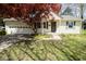 Charming single-Gathering home featuring a well-maintained lawn, attached garage, and inviting front entrance at 233 N Fenton Ave, Indianapolis, IN 46219