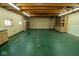 Spacious garage interior with cabinets, shelving, and an exposed beam ceiling, perfect for storage and projects at 233 N Fenton Ave, Indianapolis, IN 46219