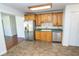 Efficient kitchen with stainless steel appliances, light wood cabinets and a sink, adjacent to additional living space at 233 N Fenton Ave, Indianapolis, IN 46219