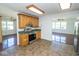 Well-lit kitchen features wood cabinetry and stainless steel appliances, offering functionality and style at 233 N Fenton Ave, Indianapolis, IN 46219