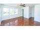 Bright living room featuring large windows, hardwood floors, and neutral paint at 233 N Fenton Ave, Indianapolis, IN 46219