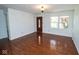 Inviting living area with hardwood floors, white walls, chandelier, and a large window for natural light at 233 N Fenton Ave, Indianapolis, IN 46219