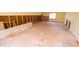 A room in the process of renovation, revealing exposed framing, and a window, ready for customization at 233 N Fenton Ave, Indianapolis, IN 46219