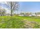 Expansive backyard featuring lush lawn, outbuildings, and potential for outdoor activities and customization at 2333 Calhoun St, Indianapolis, IN 46203