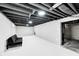 Spacious unfinished basement with exposed ceiling beams and painted walls, ready for your personal touch at 2333 Calhoun St, Indianapolis, IN 46203