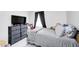 Bright bedroom showcasing a comfortable bed, dresser, and large window, creating an inviting space at 2333 Calhoun St, Indianapolis, IN 46203