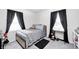Well-lit bedroom featuring a metal frame bed, a desk, and large windows for plenty of natural light at 2333 Calhoun St, Indianapolis, IN 46203