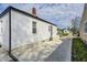 Charming exterior view of a white home with a paved driveway and a well-maintained yard at 2333 Calhoun St, Indianapolis, IN 46203