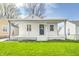 Charming bungalow with a covered porch, white siding, and well-maintained lawn at 2333 Calhoun St, Indianapolis, IN 46203