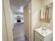 Bathroom sink with mirror adjacent to a doorway leading to the kitchen at 274 Leeds Ave, Indianapolis, IN 46201