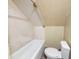 Tiled bathroom with a tub and toilet at 274 Leeds Ave, Indianapolis, IN 46201