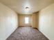 Empty bedroom with a neutral color scheme and window letting in natural light at 274 Leeds Ave, Indianapolis, IN 46201