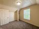 This carpeted bedroom features a closet space, window, and neutral decor at 274 Leeds Ave, Indianapolis, IN 46201