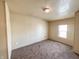 Neutral colored bedroom with carpet, one window, and a plain ceiling light at 274 Leeds Ave, Indianapolis, IN 46201