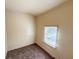 Small bedroom with carpeted floors and a window at 274 Leeds Ave, Indianapolis, IN 46201