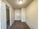 A small bedroom with carpet and a sliding door to another room at 274 Leeds Ave, Indianapolis, IN 46201
