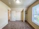 A carpeted bedroom features a closet space, window, and neutral decor at 274 Leeds Ave, Indianapolis, IN 46201