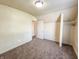 A carpeted bedroom featuring a closet space, window, and neutral decor at 274 Leeds Ave, Indianapolis, IN 46201