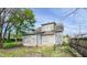 View of home's exterior showing vinyl siding, roof, and small yard with early-spring ground cover at 274 Leeds Ave, Indianapolis, IN 46201