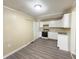 Cozy kitchen features white cabinets and hard surface floors at 274 Leeds Ave, Indianapolis, IN 46201