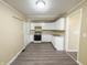Cozy kitchen features white cabinets and hard surface floors at 274 Leeds Ave, Indianapolis, IN 46201