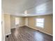 Open living room with hardwood floors, neutral paint and bright light from the window at 274 Leeds Ave, Indianapolis, IN 46201