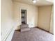 Cozy room with a carpeted floor, neutral walls, that opens to kitchen through small stairs at 274 Leeds Ave, Indianapolis, IN 46201
