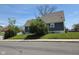 Street view of house with blue siding, a grass lawn, and a stop sign on the corner at 2819 W 16Th St, Indianapolis, IN 46222