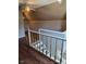Well-lit second story hallway with hardwood-look floors and white railing on staircase at 2819 W 16Th St, Indianapolis, IN 46222