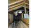 Unfinished attic with exposed wooden beams, framing, and insulation detail at 3123 S Rybolt Ave, Indianapolis, IN 46241
