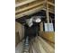 Unfinished attic space with exposed wooden beams, framing, and insulation at 3123 S Rybolt Ave, Indianapolis, IN 46241