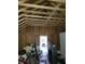 Unfinished building interior with wooden framing, showing potential for customization and a peek of the outside at 3123 S Rybolt Ave, Indianapolis, IN 46241