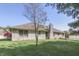 Charming backyard featuring a well maintained lawn, a brick chimney, and hints of trees, perfect for outdoor relaxation at 3427 Brunswick Ave, Indianapolis, IN 46227