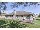 This home boasts a well-manicured backyard, complete with a concrete patio area and a classic brick chimney at 3427 Brunswick Ave, Indianapolis, IN 46227