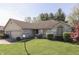 Beautiful single-story home with a manicured lawn, mature trees and a brick facade at 3427 Brunswick Ave, Indianapolis, IN 46227