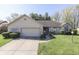 Charming single-story home with a well-manicured lawn and a two-car garage, showcasing curb appeal at 3427 Brunswick Ave, Indianapolis, IN 46227