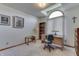 Bright home office featuring a large window, desk, built-in shelving, and neutral walls at 3427 Brunswick Ave, Indianapolis, IN 46227